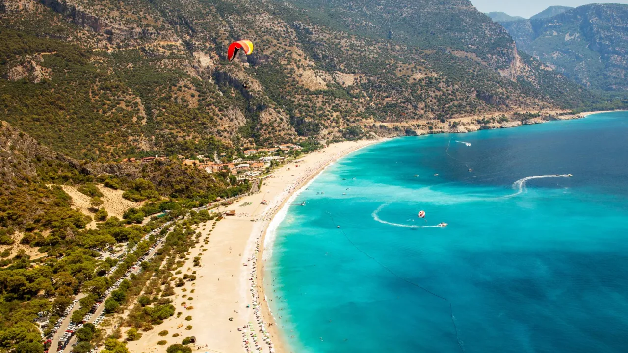 Long sandy beach and turquoise sea near Fethiye on Turkey Greece slow travel experience