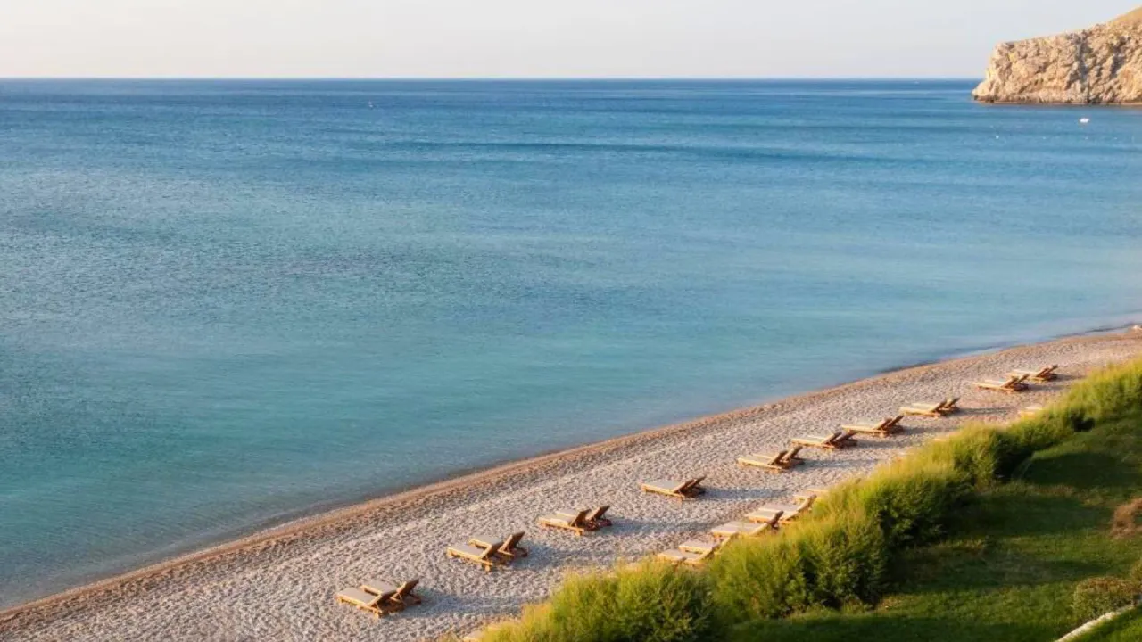 Peaceful beach with sunbeds on the Aegean coast during Aegean Flow tour