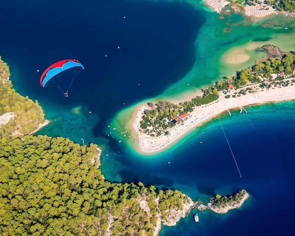 Paraglider soaring over the famous Blue Lagoon in Oludeniz, Turkey.