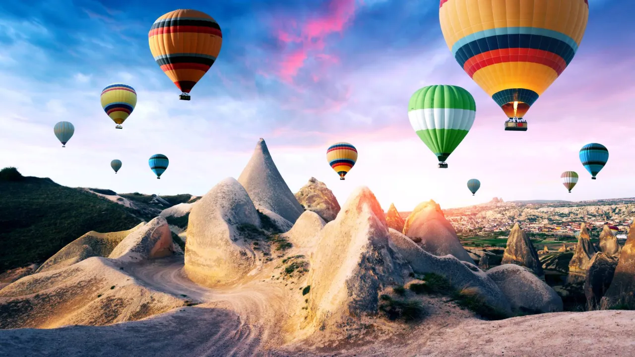 Hot air balloons over fairy chimneys in Cappadocia on Antalya Cappadocia journey