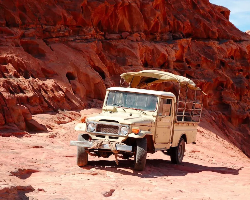 4x4 jeep ready for a desert adventure among Wadi Rum's iconic red dunes.