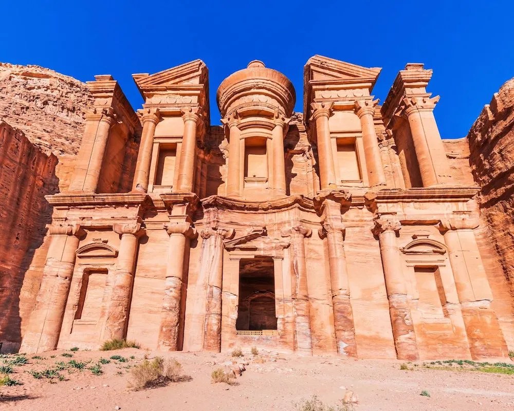 Majestic view of The Monastery (Ad Deir) carved into the rock cliffs of Petra, Jordan.