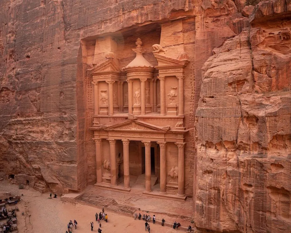 Detailed view of the ancient Treasury carved into the rose-red cliffs of Petra, Jordan.