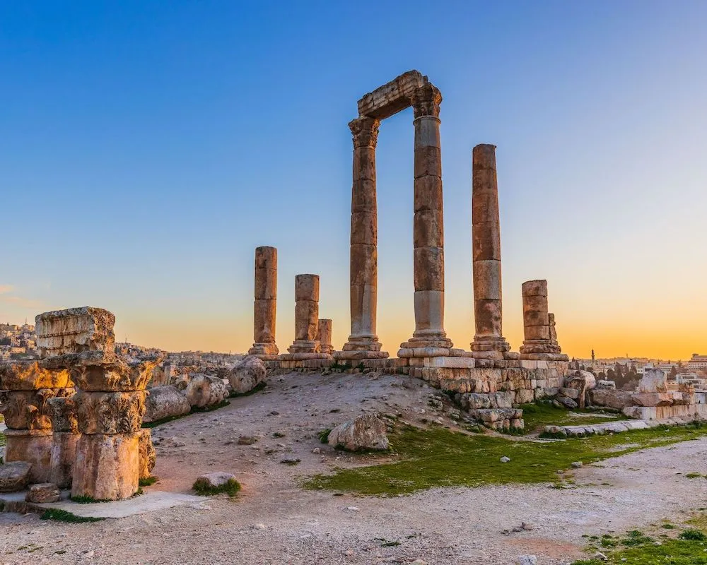 Ancient Roman pillars of the Amman Citadel at sunset in Jordan.
