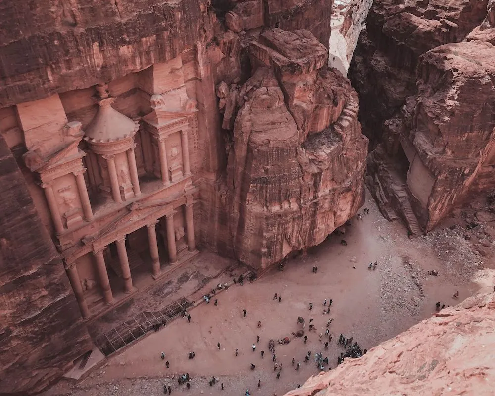 Stunning aerial perspective of Petra's monumental Treasury surrounded by rugged cliffs.